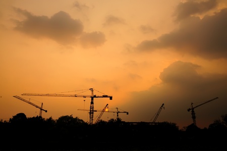 Silhouette of contruction crane at sunsetの写真素材