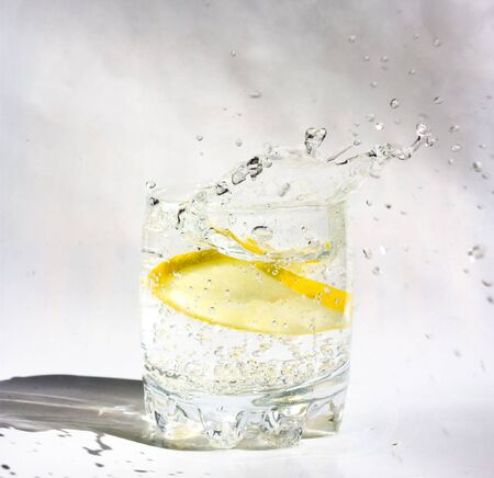Lemon in glass. Splash frozen.の写真素材