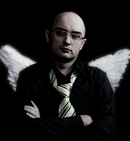 Man with white angel wings behind  Over black background  In studio の写真素材