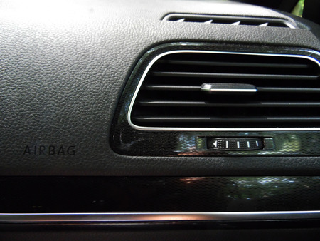 Airbag sign/symbol infont of the passenger seat in the car beside the air controlerの写真素材