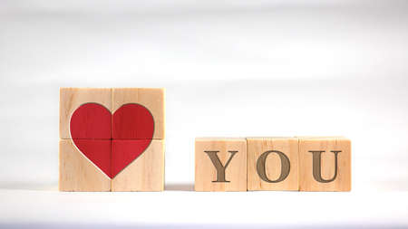 Red hearts and letters are displayed on square wooden blocks.の写真素材