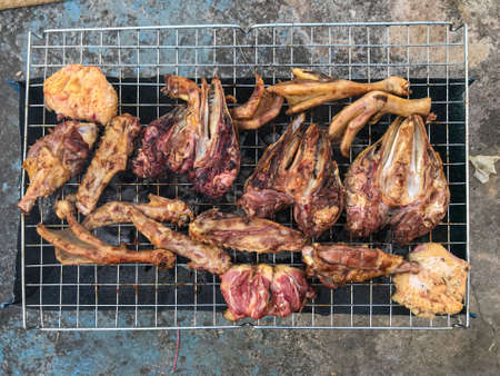 Duck meat that has been split into pieces Then being marinated with sauce And are roasting on the...