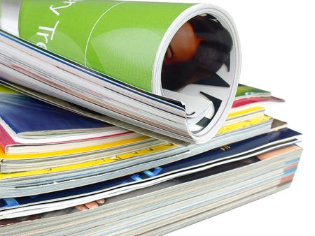 Many colourful magazines on the white background.の写真素材