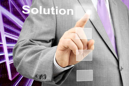 Businessman Selecting Solution Button on Virtual Screenの写真素材