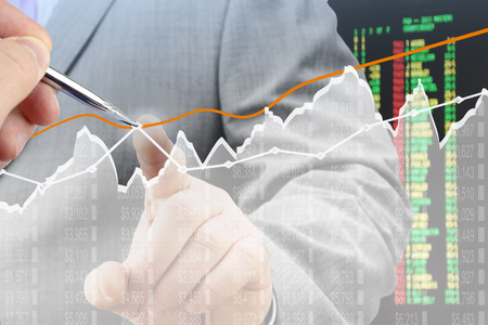 Businessmen analyzing financial chart on virtual screenの写真素材