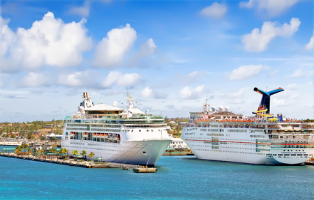 NASSAU, BAHAMAS - APRIL 13, 2015: Royal Caribbean cruise ship Grandeur of the Seas and Carnival Fascination docked at port on the sunny dayのeditorial素材