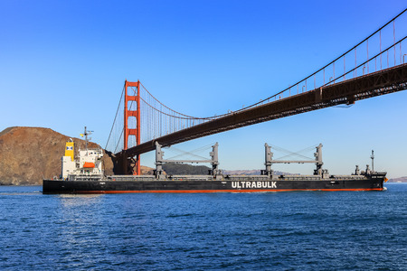 SAN FRANCISCO, CALIFORNIA, USA - OCTOBER 26, 2017: San Francisco Golden Gate Bridge and cargo ship...