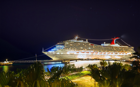 WILLEMSTAD, CURACAO - APRIL 04, 2018:  Cruise ship Carnival Conquest docked at port Willemstad at night.のeditorial素材