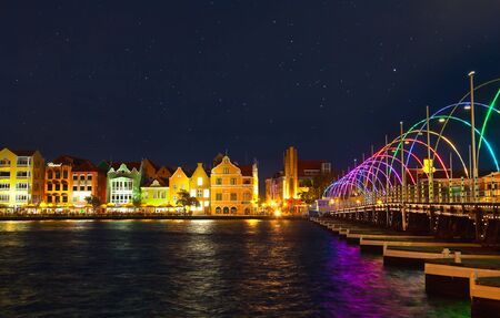 Willemstad, Curacao - April 12, 2018: Willemstad by night with the famous old colonial facades and Illuminated Queen Emma Bridgeのeditorial素材