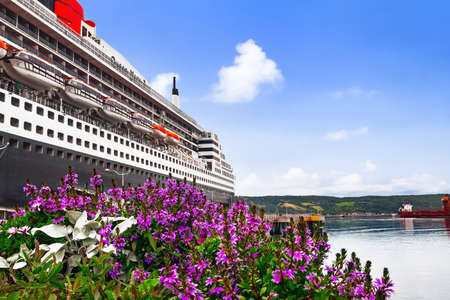 SAGUENAY, QC, CANADA - SEPTEMBER 10, 2019: RMS Queen Mary 2 ship docked at port. She is the largest ocean liner ever built, having served as the flagship of the Cunard Lineのeditorial素材