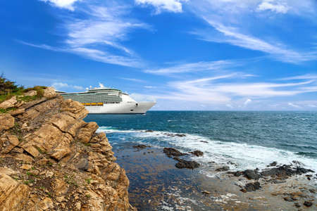 Luxury cruise ship sailing from port on sunny dayの写真素材