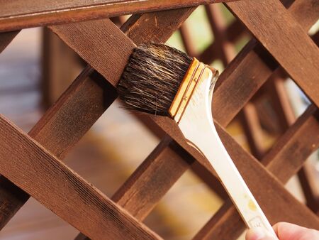 A fence is applied by a brush.の写真素材