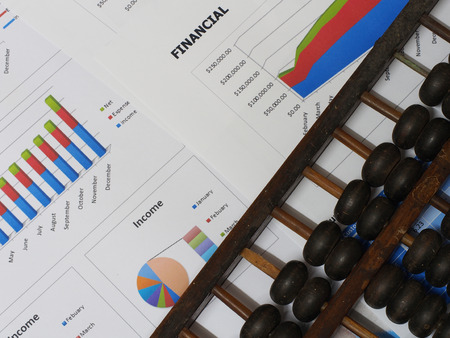 Business chart and a vintage chinese abacusの写真素材