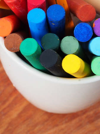 education concept. Crayons in a mug on a wooden tableの写真素材