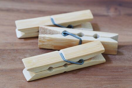 wooden cloth pegs on wooden backgroundの写真素材