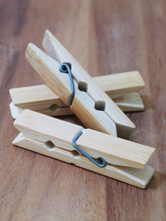 wooden cloth pegs on wooden backgroundの写真素材
