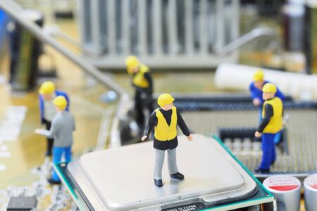 Group of engineer workers are installing CPU (Central Processing Unit) on mainboard. Technology...