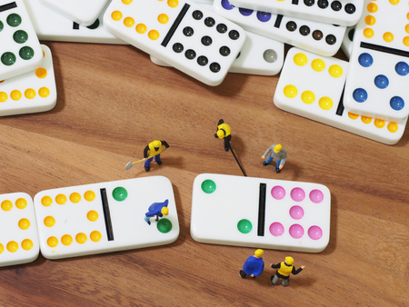 Group of engineer workers are making dominos