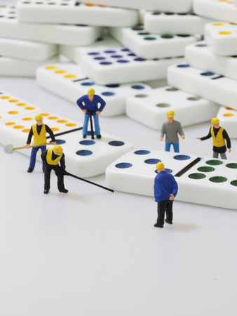 Group of engineer workers are making dominos