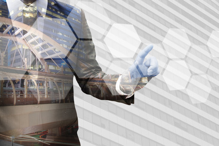 Double exposure businessman hand touching tactile polygon interfaceの写真素材