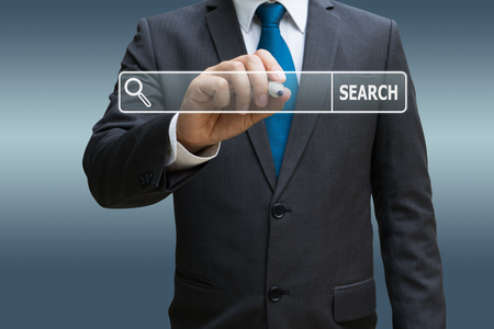 Businessman hand touching virtual panel of internet searching screenの写真素材