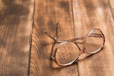 A pair of glasses on a wooden tableの写真素材