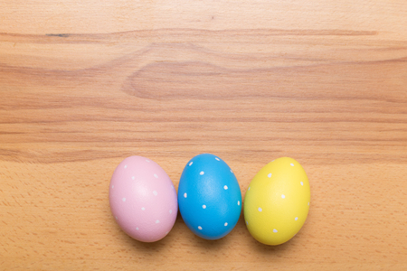 Easter eggs on wooden table. Holiday backgroundの写真素材