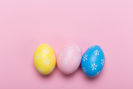 Colorfull easter eggs in nest on pastel color background with space. Conceptの写真素材