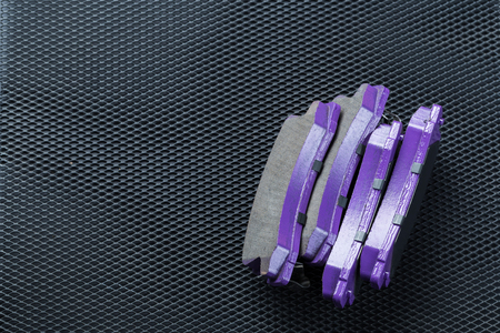 A set of new automobile brake pads on a black backgroundの写真素材