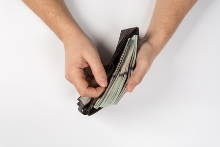 Man holding a wallet isolated on white backgroundの写真素材