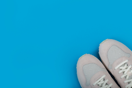 Overhead Shot Of White Sneakers On paper blue Backgroundの写真素材