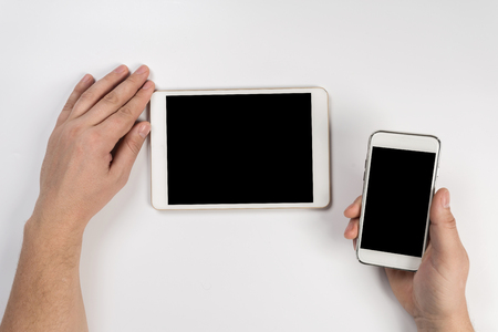 Hand touch on empty screen of tablet above brown table top view, Leave space for display of your content, Technology concept, mock up for montage your contentの写真素材