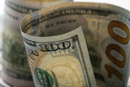 American dollars. A stack of hundred dollar bills. Close up of new hundred dollar bill on the white background.の写真素材
