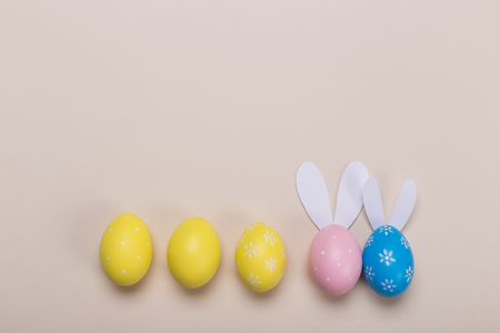 Colorfull easter eggs in nest on pastel color background with space. Conceptの写真素材
