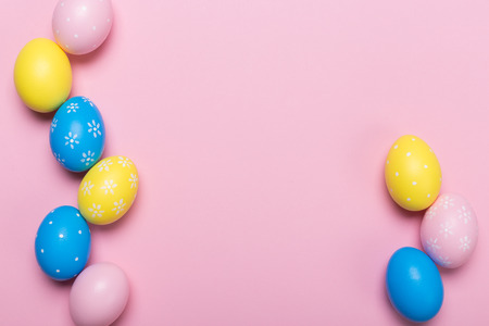 Colorfull easter eggs in nest on pastel color background with space. Concept