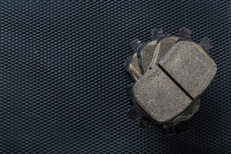 A set of new automobile brake pads on a black backgroundの写真素材