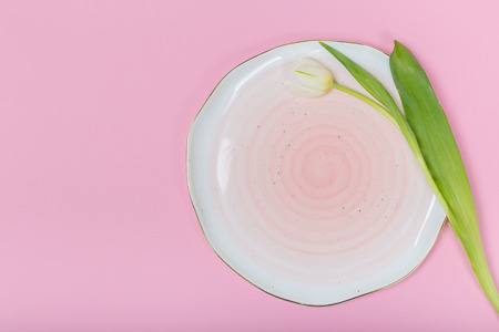 Pinks ceramic plates on pink background. Flat lay, top view.の写真素材