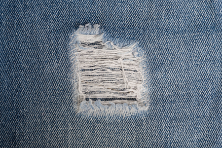 White stitching on blue denim jeans patch. Close up blue jean frameの写真素材