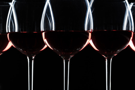 glass of red, rose and white wine over black background. Wine card menu design. Closeup of wineglasses with luxury wines for wine tastingの写真素材