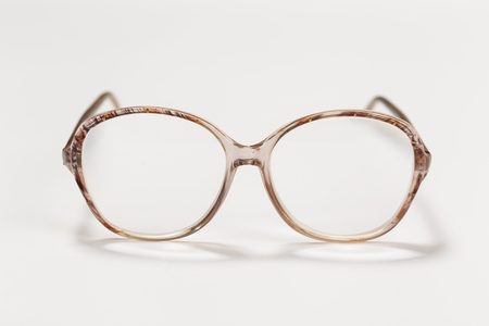 Front view of reading glasses with tortoiseshell frames on white backgroundの写真素材