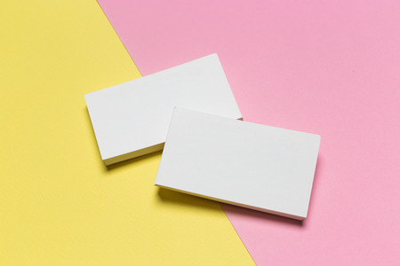 Business cards Mockup on two color background. pink and yellow backgroundの写真素材