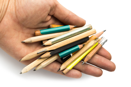 hand holds many short pencils isolated on white background.の写真素材