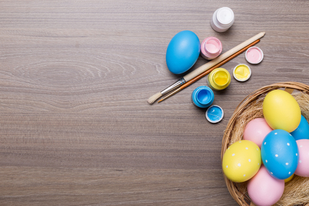 painting Easter eggs on wooden backgroundの写真素材