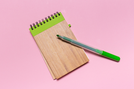 school notebook on a pink background, notepad on a table.Top viewの写真素材