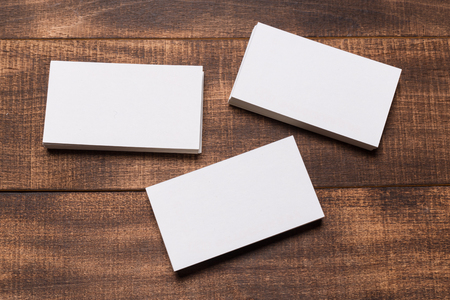 Mock up of business cards on dark wood backgroundの写真素材