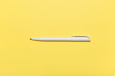 white pen on a yellow background. conceptの写真素材