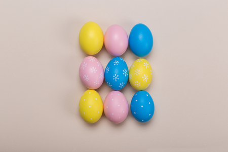 Colorfull easter eggs in nest on pastel color background with space. Conceptの写真素材