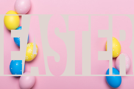 Colorfull easter eggs in nest on pastel color background with space. Conceptの写真素材