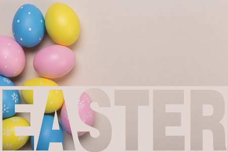 Colorfull easter eggs in nest on pastel color background with space. Conceptの写真素材