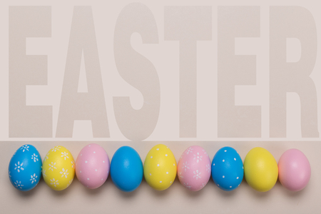 Colorfull easter eggs in nest on pastel color background with space. Conceptの写真素材